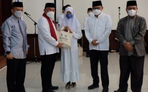 Wali Kota Depok, Mohammad Idris (kedua dari kiri) saat menyerahan bantuan kepada salah satu anak yatim pada acara peringatan Tahun Baru Islam 1 Muharam 1444 Hijriah Tingkat Kota Depok di aula Teratai, Balai Kota Depok, Rabu (03/08/22)